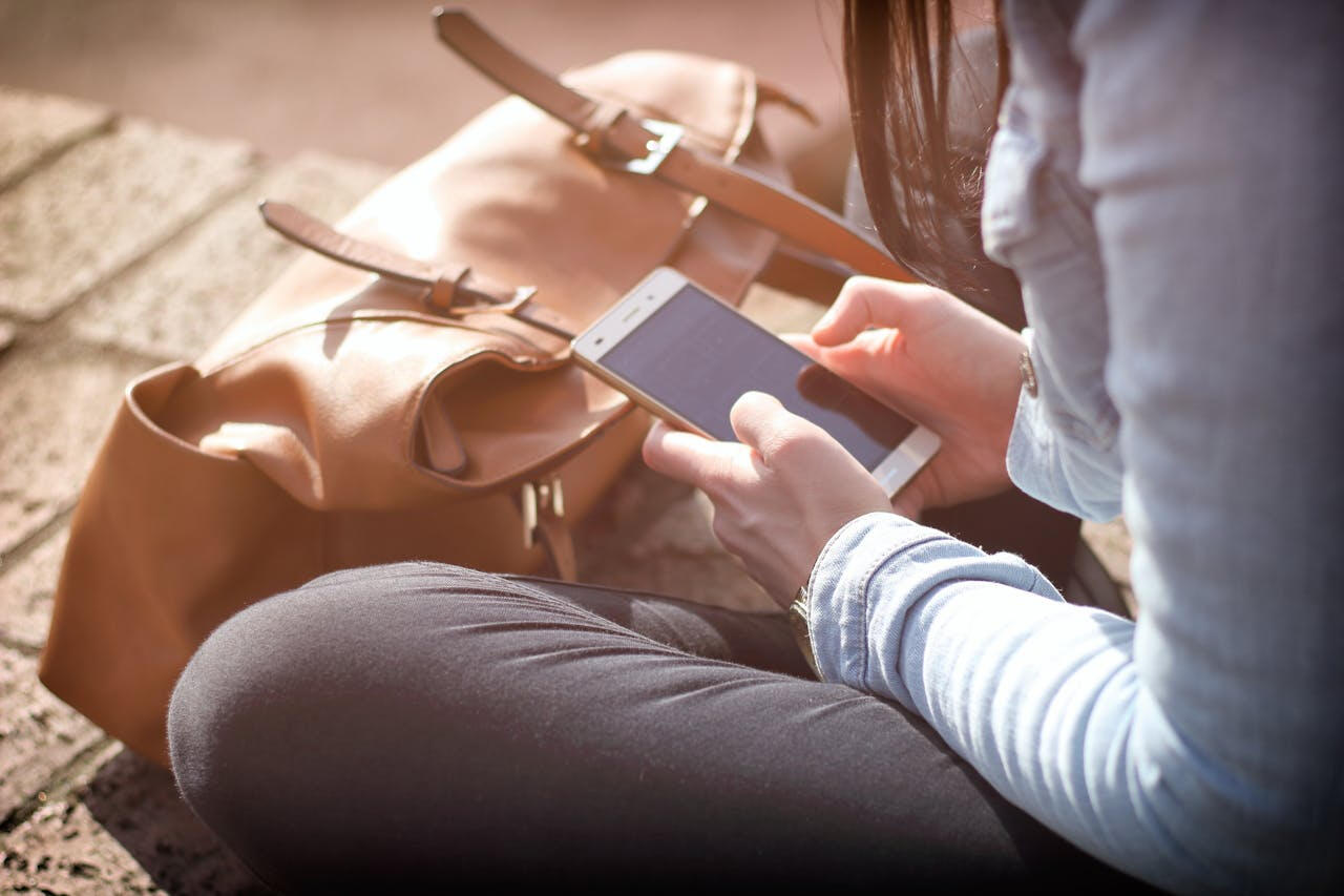 A company owner viewing their Utah custom website, with search engine optimization (SEO) services included, on their mobile device.